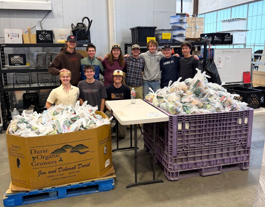 Volunteer group next to the KidsPack bags they made.
